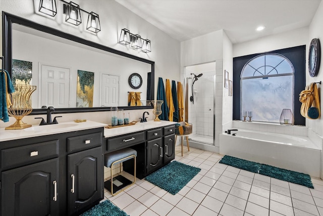 bathroom with plus walk in shower, tile patterned floors, and vanity