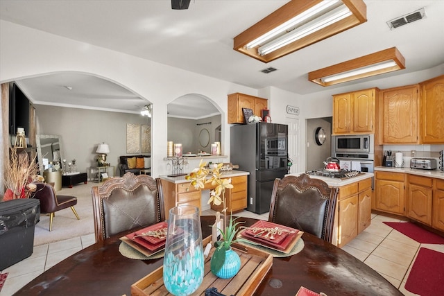 tiled dining space featuring ceiling fan