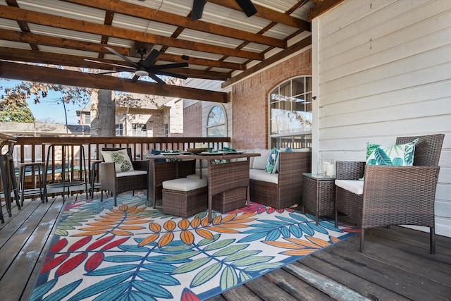 wooden deck with ceiling fan and outdoor lounge area