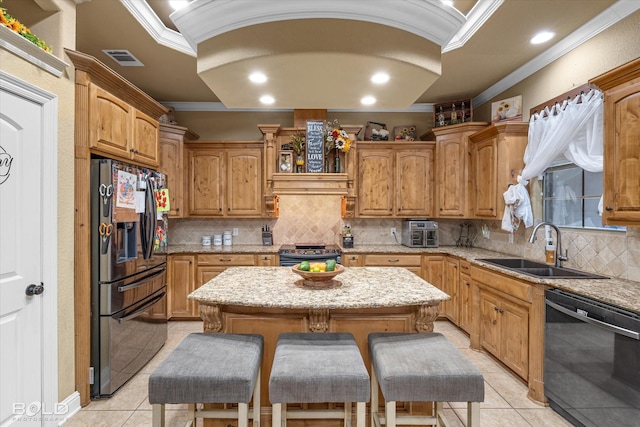 kitchen with a kitchen island, sink, a kitchen bar, ornamental molding, and stainless steel appliances