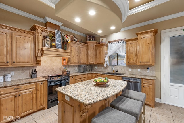 kitchen with sink, light stone countertops, black stove, a kitchen island, and stainless steel dishwasher