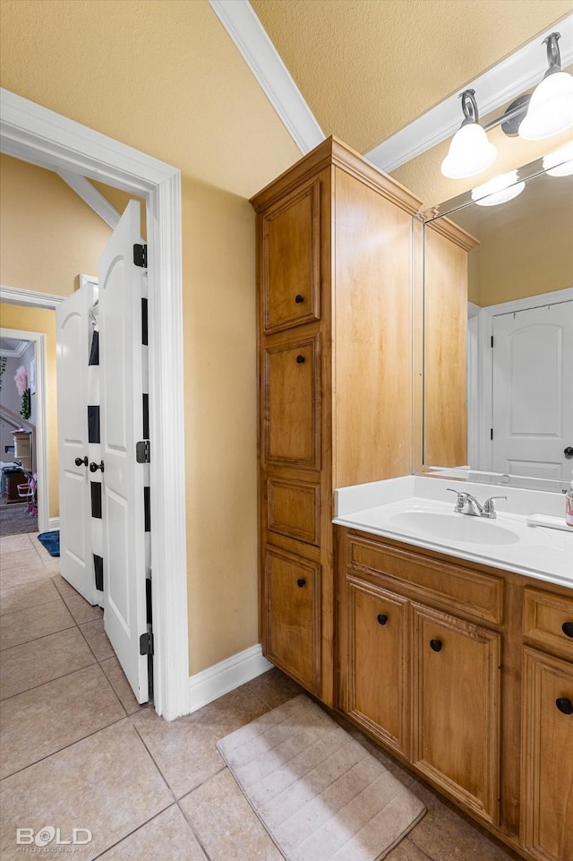 bathroom with crown molding, tile patterned floors, vanity, and a textured ceiling