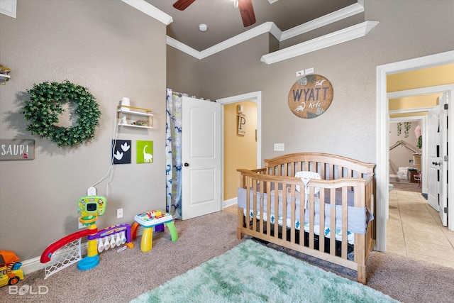 tiled bedroom with a nursery area, ceiling fan, and ornamental molding