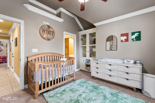 carpeted bedroom featuring a crib, crown molding, and ceiling fan