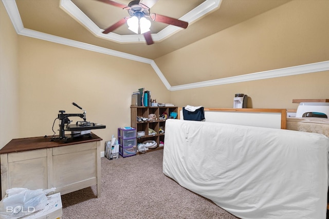 carpeted bedroom with lofted ceiling, crown molding, and ceiling fan