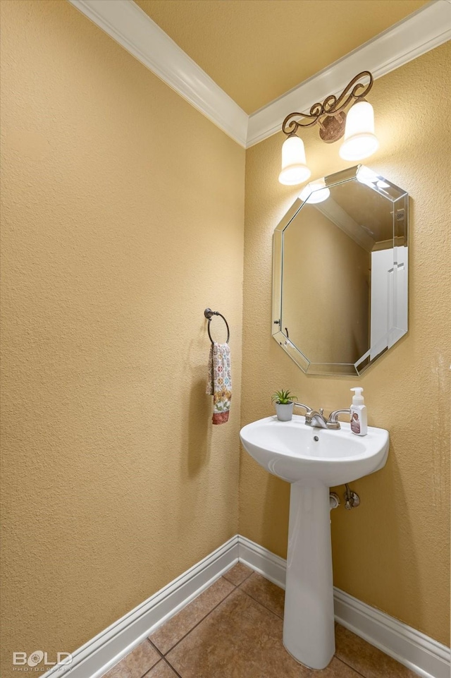 bathroom with crown molding and tile patterned floors