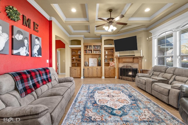 living room with crown molding, coffered ceiling, light tile patterned flooring, and built in shelves