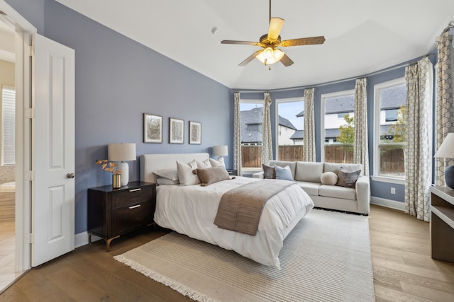 bedroom featuring vaulted ceiling, hardwood / wood-style floors, and ceiling fan