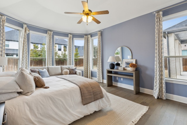 bedroom with dark hardwood / wood-style floors and ceiling fan