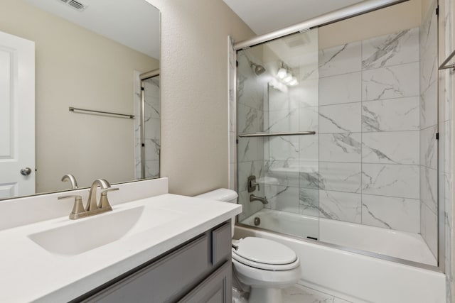 full bathroom featuring bath / shower combo with glass door, vanity, and toilet