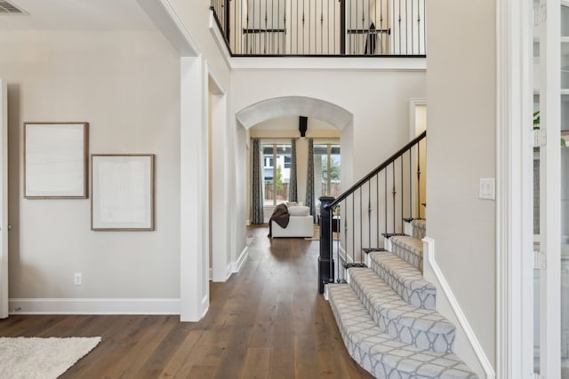 entryway featuring a high ceiling and dark hardwood / wood-style floors