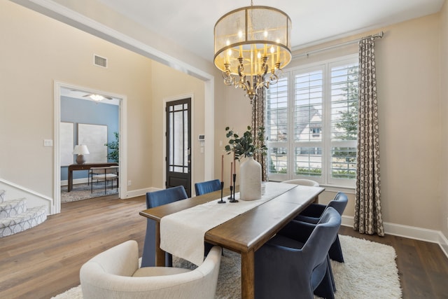 dining space featuring hardwood / wood-style flooring, a chandelier, and a wealth of natural light