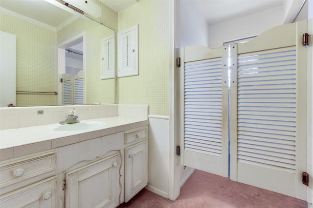 bathroom featuring ornamental molding and vanity