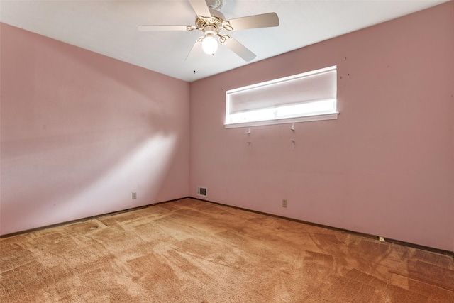 empty room with ceiling fan and light carpet