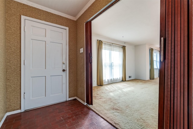 carpeted entrance foyer with crown molding