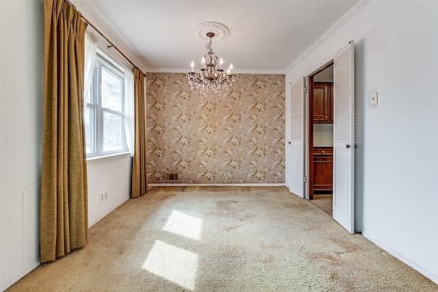 empty room featuring crown molding, light colored carpet, and a chandelier