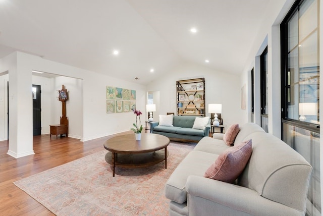 living room featuring vaulted ceiling and hardwood / wood-style floors