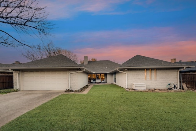 view of front of property with a yard and a garage