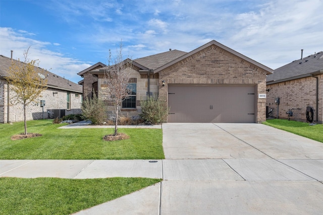 view of front of home with central AC, a garage, and a front lawn