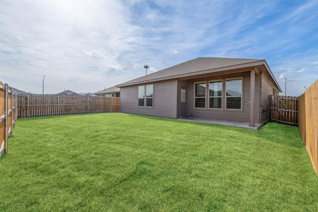 rear view of house featuring a yard