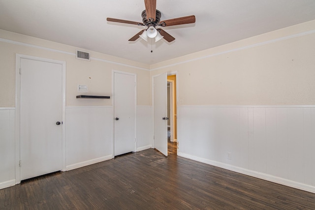 unfurnished bedroom with dark wood-type flooring and ceiling fan