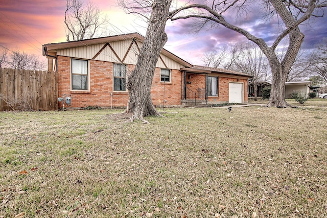 view of front facade with a garage and a yard