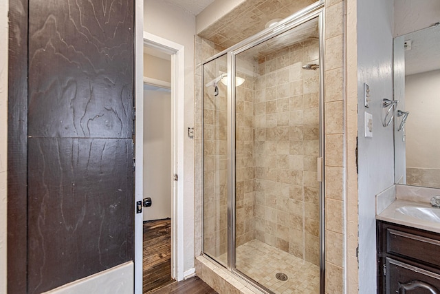 bathroom with vanity, wood-type flooring, and walk in shower