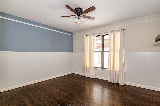 unfurnished room with dark hardwood / wood-style flooring and ceiling fan