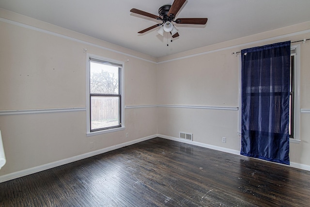 empty room with dark wood-type flooring and ceiling fan