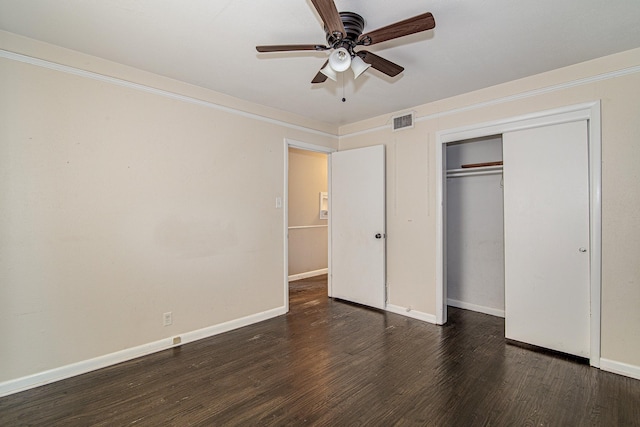 unfurnished bedroom featuring dark hardwood / wood-style flooring, a closet, and ceiling fan