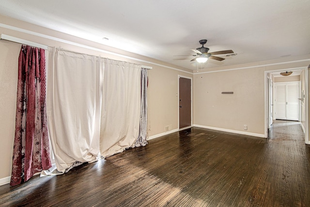 spare room featuring ceiling fan and dark hardwood / wood-style flooring