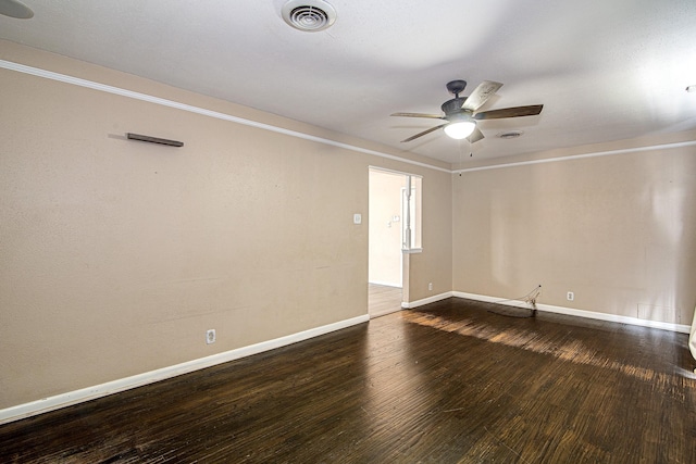 spare room with ceiling fan and dark hardwood / wood-style flooring