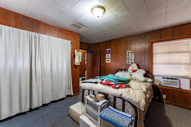 carpeted bedroom featuring wooden walls