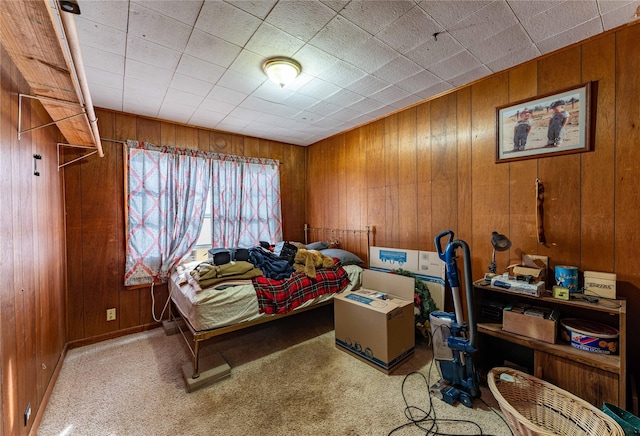 carpeted bedroom with wooden walls