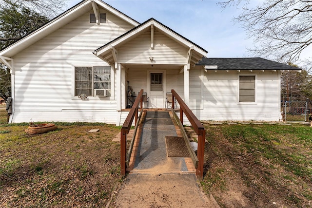 bungalow-style home with covered porch and a front lawn