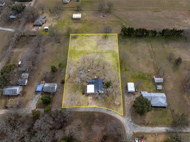 birds eye view of property with a rural view