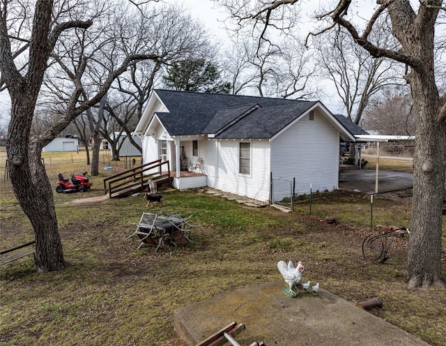 view of side of home with a carport