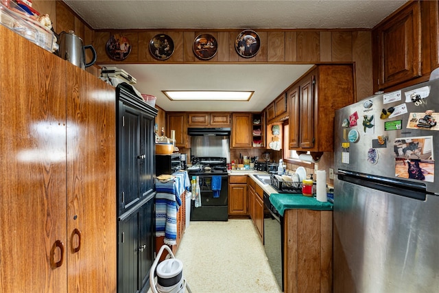 kitchen featuring a textured ceiling and black appliances