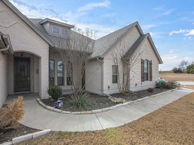 view of side of home with a yard