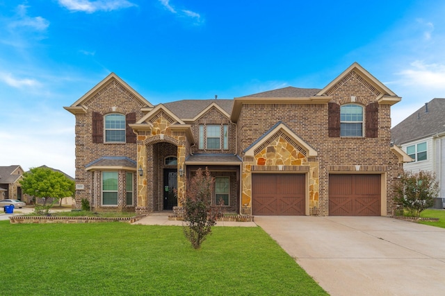 view of front of house with a garage and a front lawn