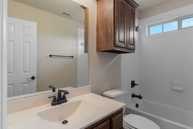 full bathroom featuring vanity, bathing tub / shower combination, and toilet