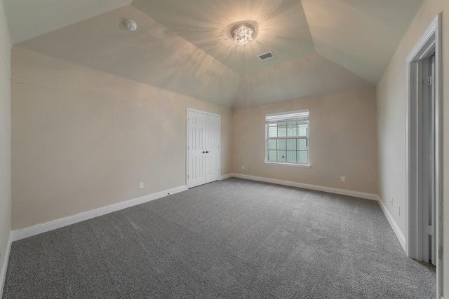 unfurnished bedroom with lofted ceiling, carpet floors, and a tray ceiling