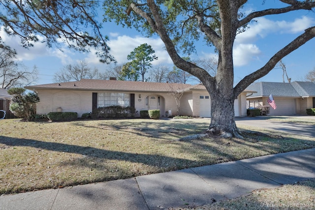 single story home featuring a garage and a front yard