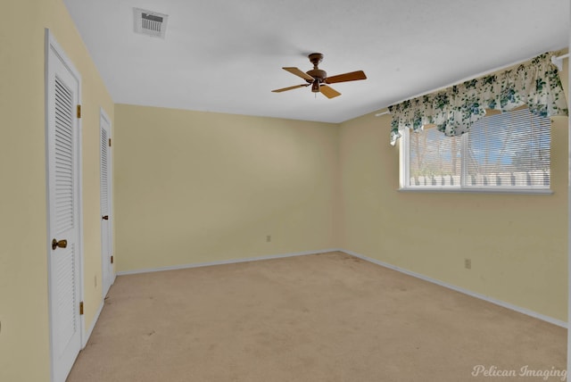 unfurnished bedroom with ceiling fan and light carpet