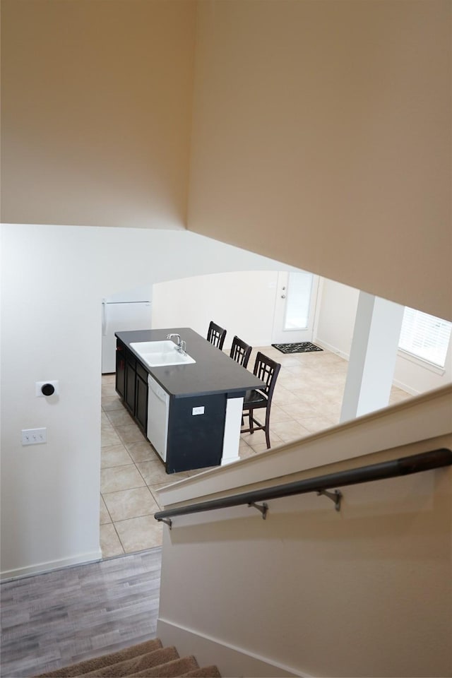 stairway with tile patterned floors and baseboards