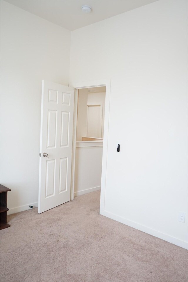 unfurnished bedroom with baseboards and carpet floors
