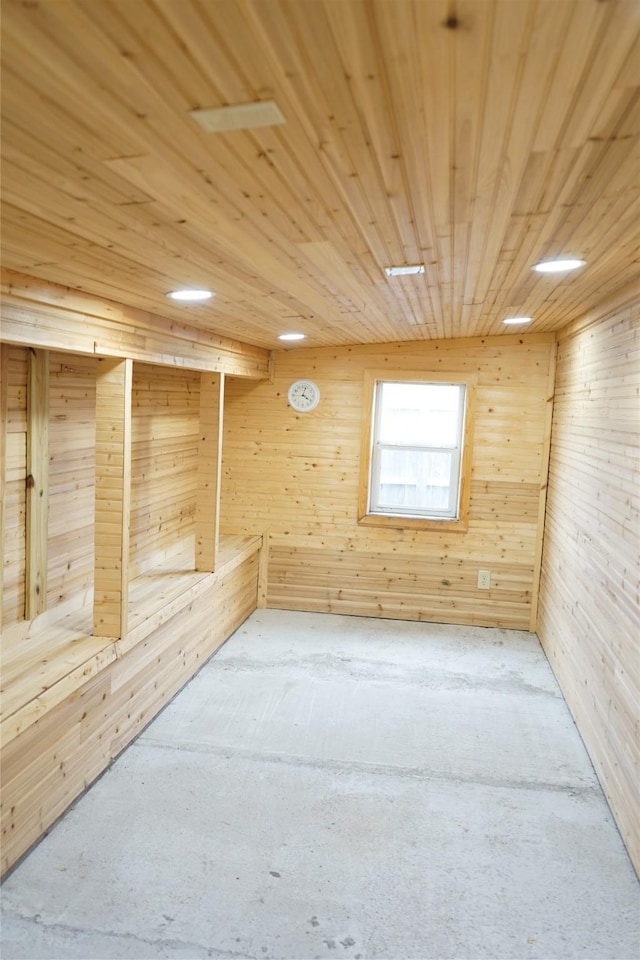 unfurnished room with wooden walls and wooden ceiling