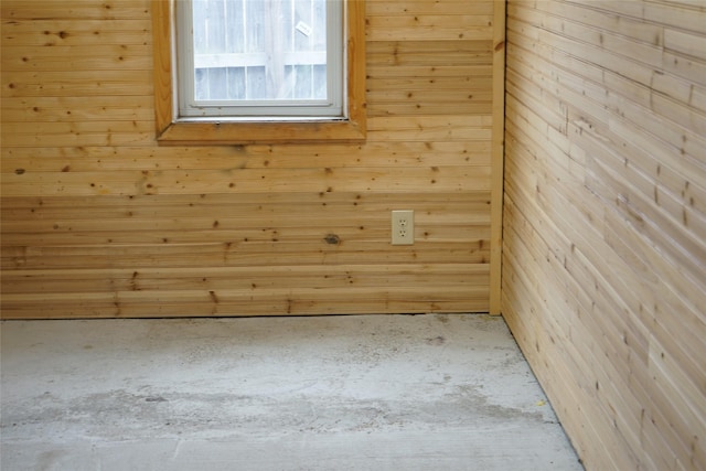 spare room featuring wooden walls