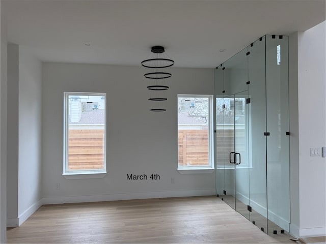 interior space featuring baseboards and wood finished floors