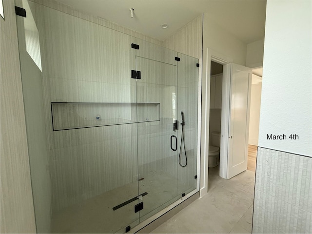 full bath with toilet and a stall shower